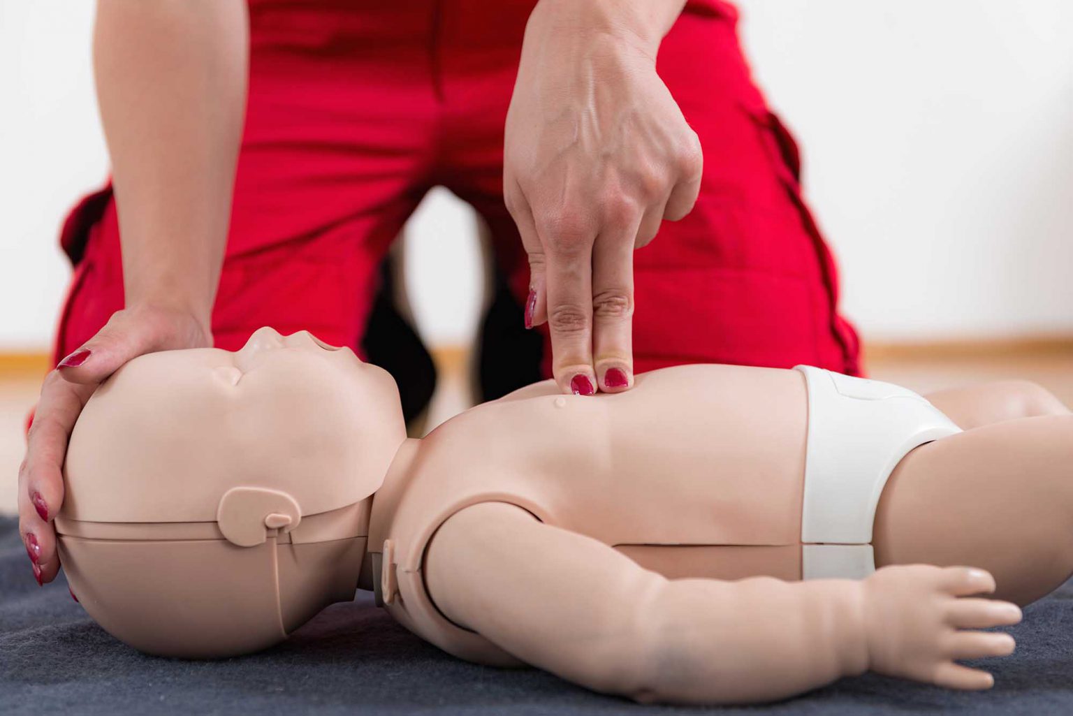 First Aid Training - Cardiopulmonary resuscitation. First aid course on baby dummy